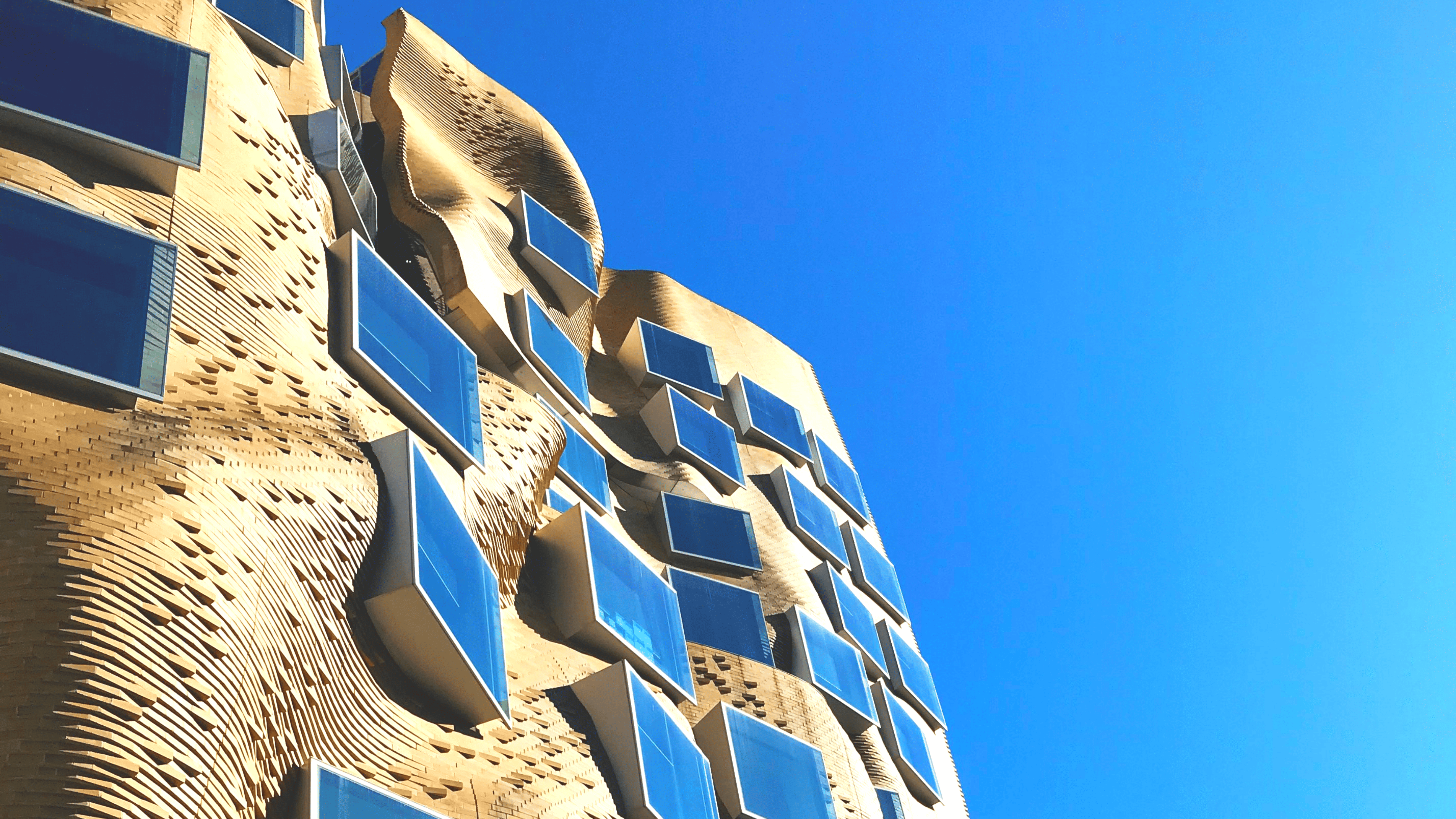 Image depicts Frank Gehry's "paper bag" business school building. Building 8 of Univeristy Technology Sydney. The image represents Asendium's collaboration with UTS' financial planning master's course.